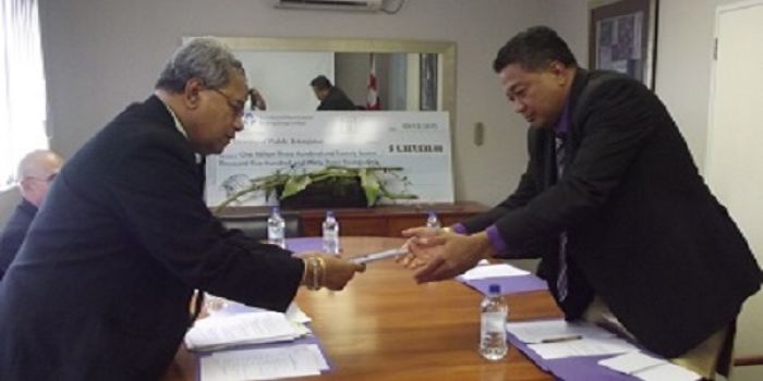 Chairman of TAL Lisiate 'Akolo presented divident to Hon. Poasi Tei Minister of Public Enterprises